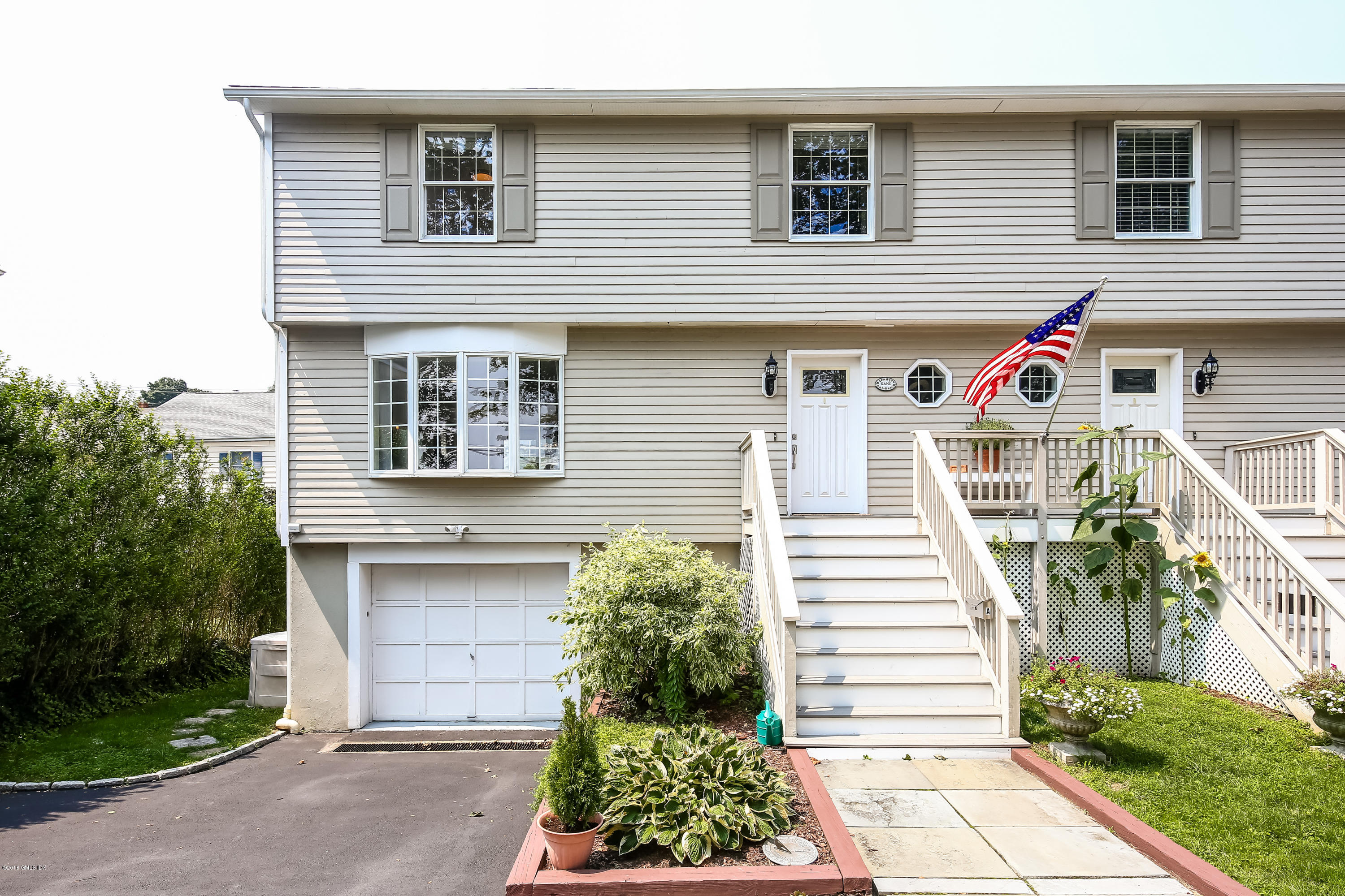 52 Ute Place, Unit A Greenwich, CT 06830 - Photo 3 of 32 a front view of a house with a yard