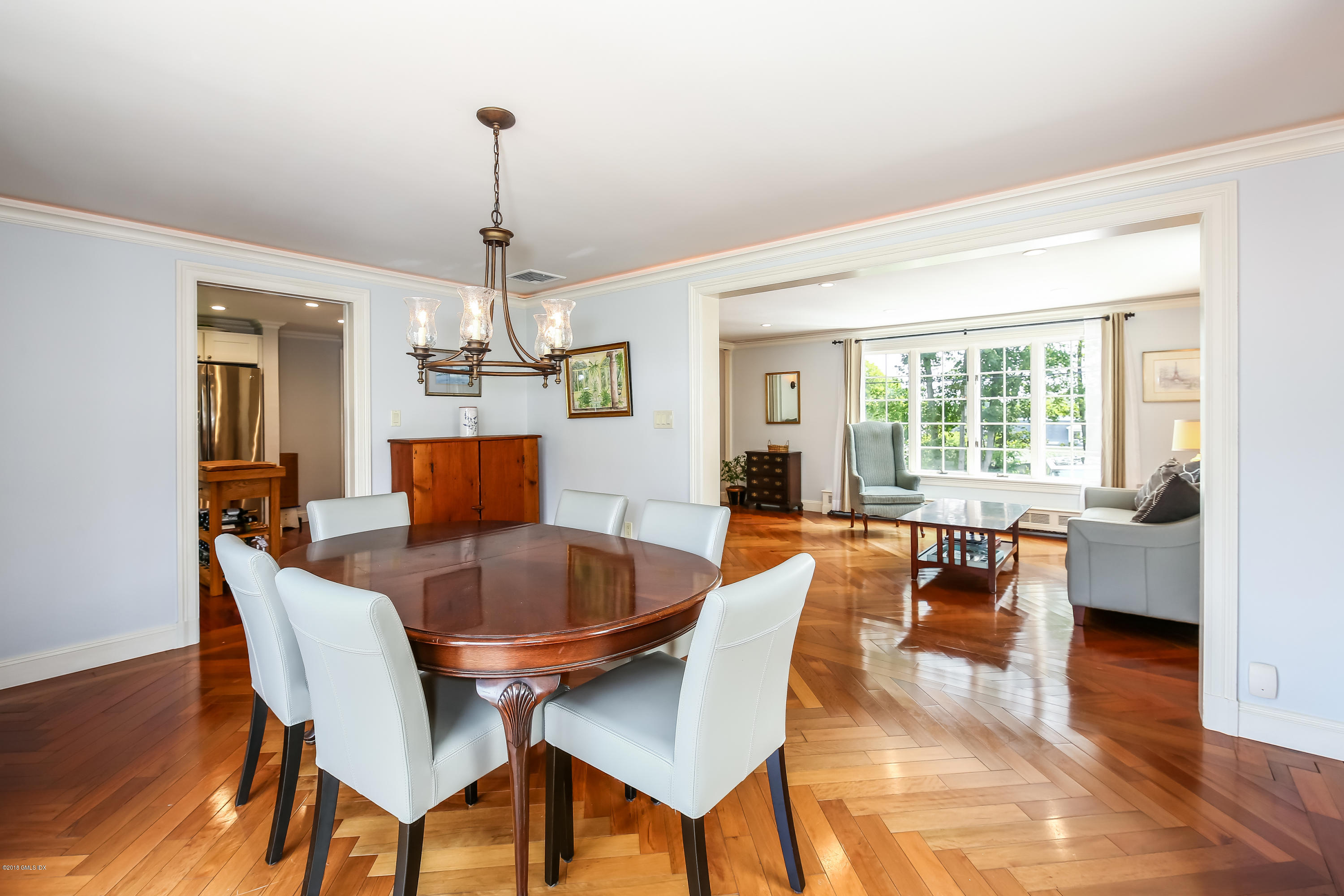 52 Ute Place, Unit A Greenwich, CT 06830 - Photo 9 of 32 a dining room with furniture a chandelier and wooden floor