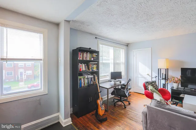 a view of a livingroom with workspace and a window
