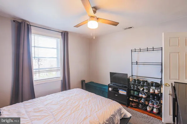 a bedroom with a bed and a window