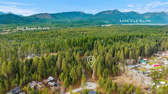 a view of a lush green hillside and houses