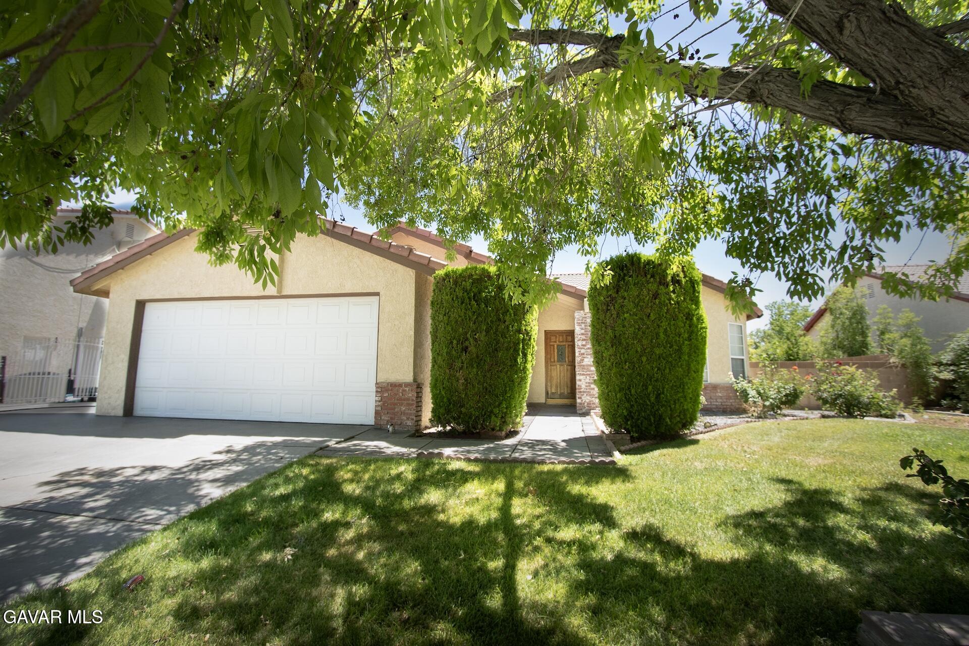 44318 33rd Street West Lancaster, CA 93536 - Photo 1 of 29 a view of a house with yard and tree s