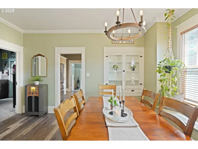 a living room with furniture and a dining table