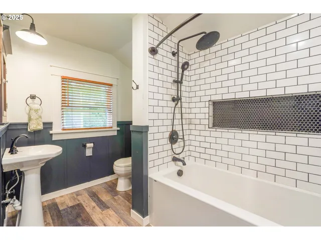 a bathroom with a sink a toilet and bathtub