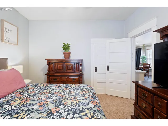 a bedroom with a bed and a television