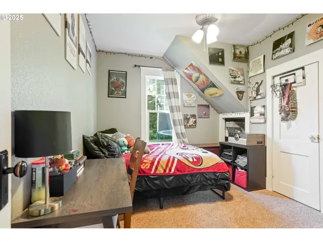 a bedroom with bed and a flat tv screen