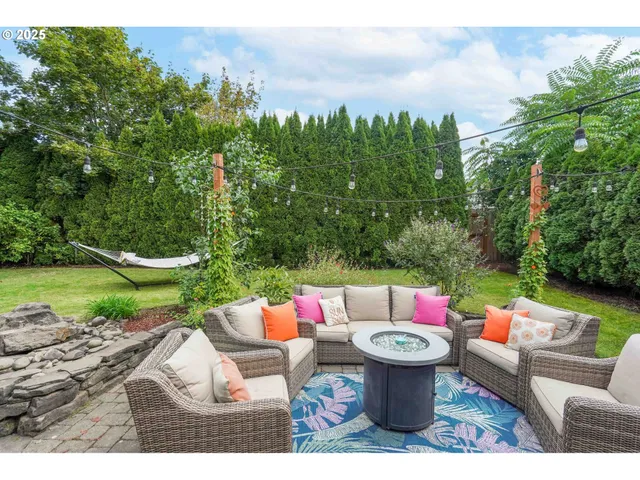 a aerial view of a house with a yard and sitting area
