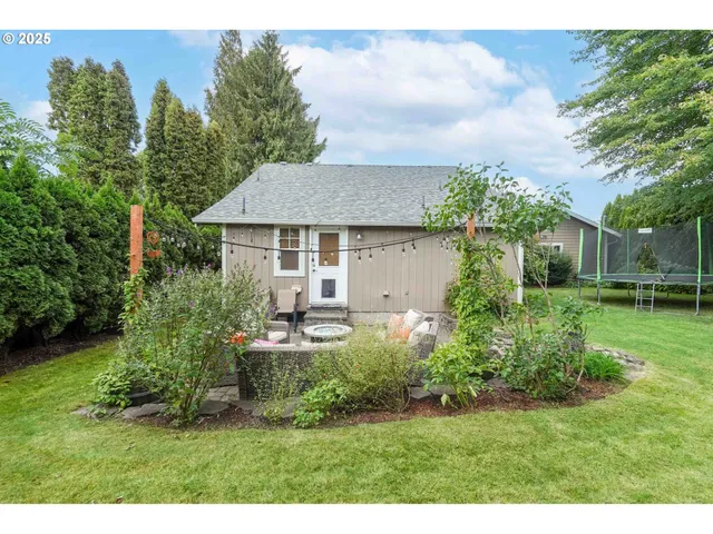 a view of a house with a yard and sitting area