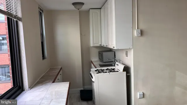 a view of a storage and utility room with washer and dryer