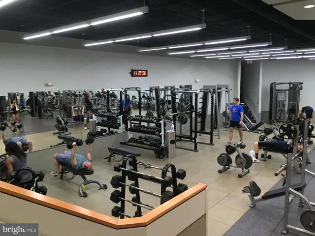 a room with gym equipment and lots of clutter