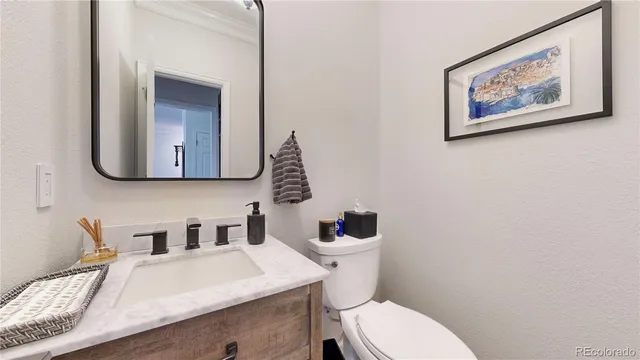 a bathroom with a toilet a sink and mirror