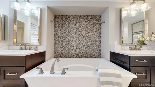 a bathroom with a bathtub sink and mirror