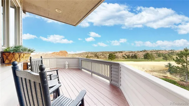a view of roof deck with two chairs and wooden floor