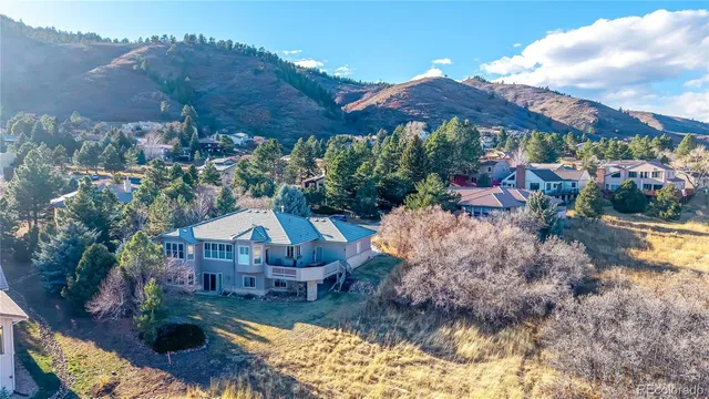 a aerial view of a house with a yard basket ball court and outdoor seating