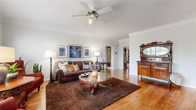 a living room with furniture a rug and a chandelier