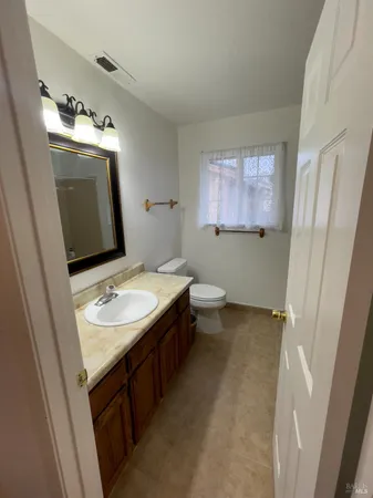 a bathroom with a sink toilet and mirror