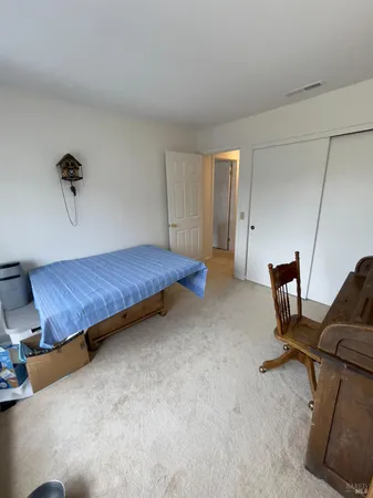 a bedroom with a bed and cabinets