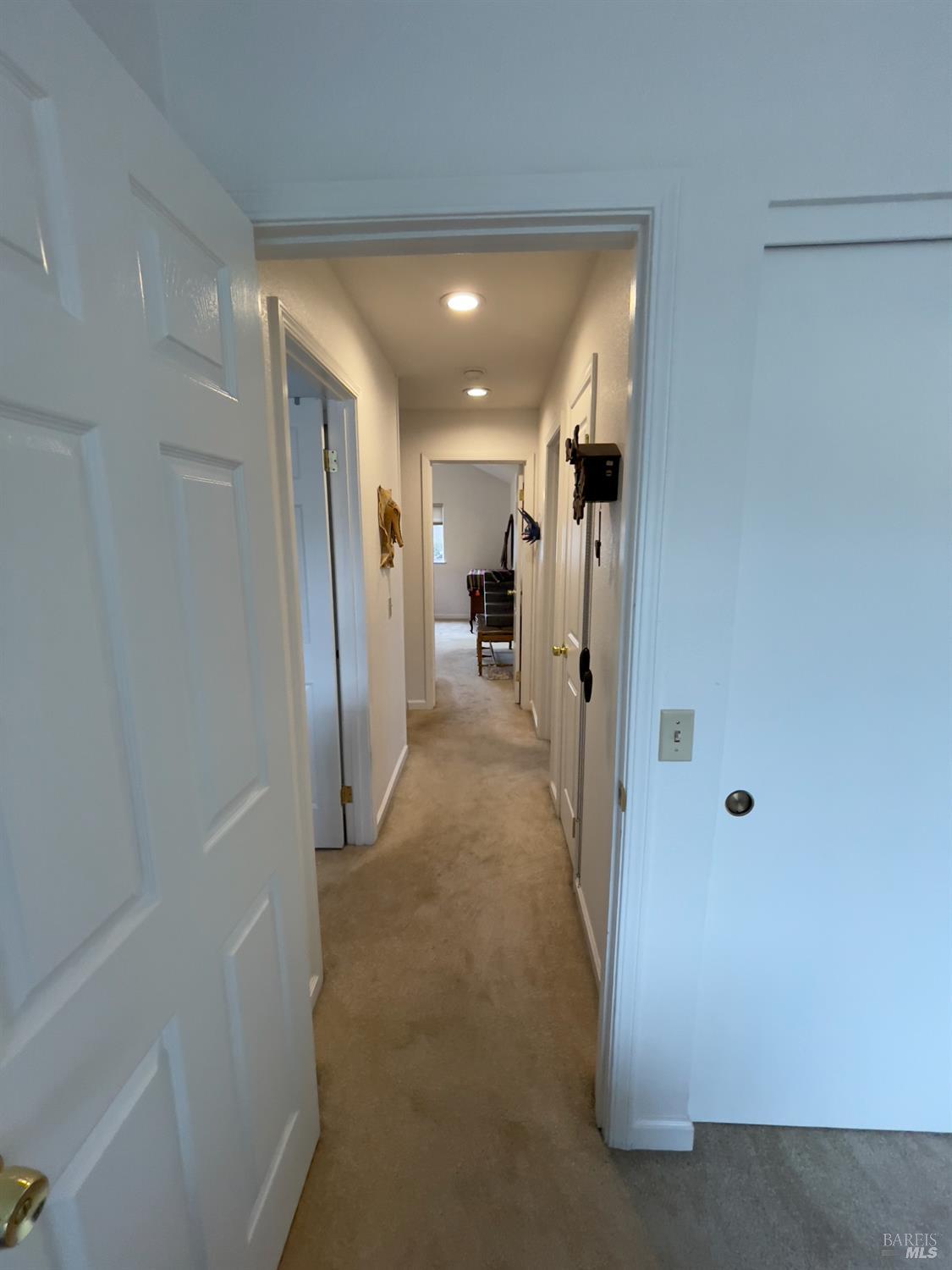 6191 San Carlos Court Rohnert Park, CA 94928 - Photo 18 of 37 a view of a hallway with wooden shelves