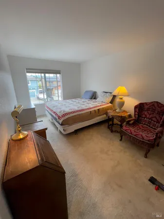 a bedroom with furniture and a window