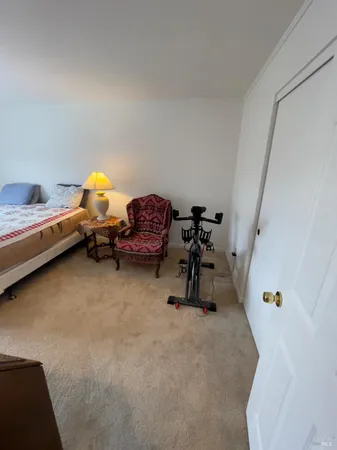 a bedroom with furniture and a air conditioner vent