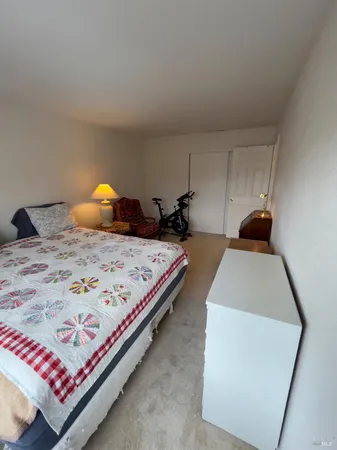 a bedroom with a bed and a lamp