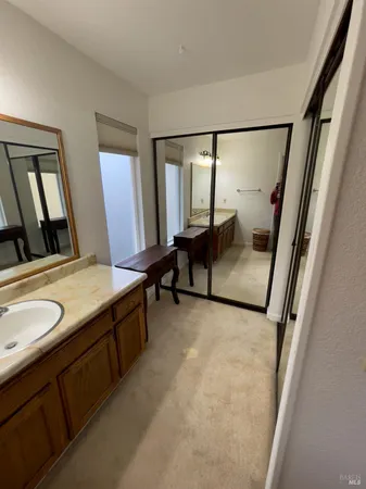 a living room with furniture and a sink