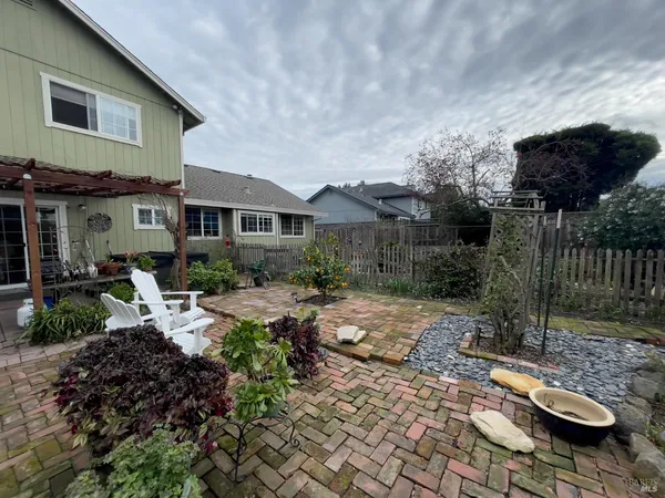 a view of backyard with patio and outdoor seating