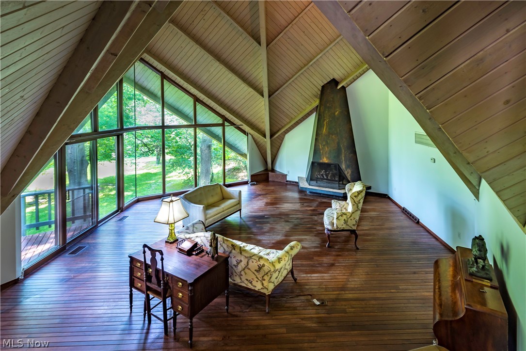 1 Pepper Ridge Road Cleveland, OH 44124 - Photo 5 of 23 View of great room. Ceilings are 30-35 feet in height at its peak. 15 feet tall wood burning fireplace. Fantastic views of the property. Great room 28x27 with original wood flooring. Walls of windows.