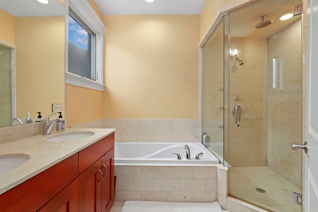 a bathroom with a tub a sink and shower