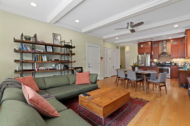 a living room with furniture a rug and a bookshelf