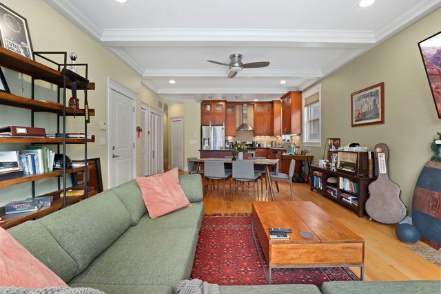 a living room with furniture and a book shelf