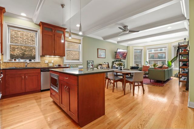 a kitchen with large cabinets appliances and a dining table