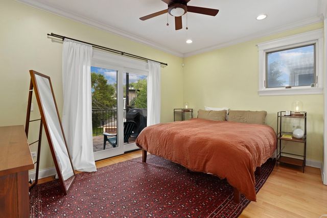 a spacious bedroom with a bed and a flat screen tv