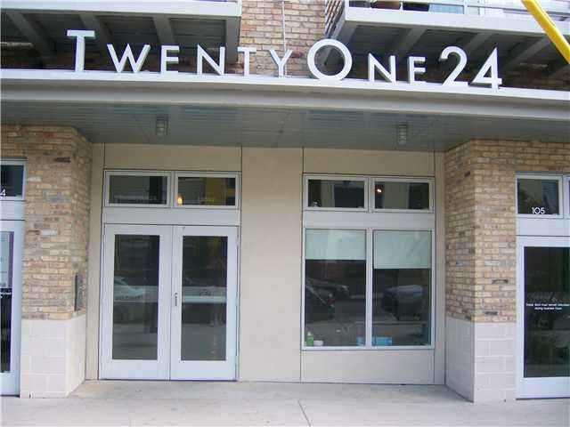 View of exterior entry with french doors, brick siding, and a patio