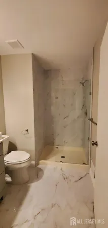 a bathroom with a toilet and a shower