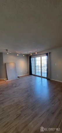 a view of room and hall with wooden floor