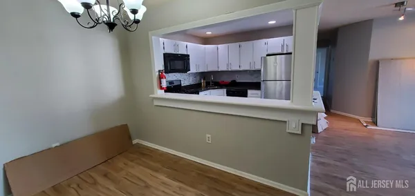 a kitchen with kitchen island stainless steel appliances a refrigerator and a counter top space