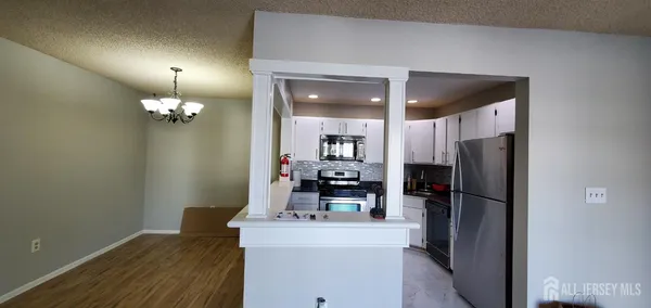 a kitchen with a refrigerator and a table