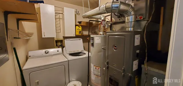 a close up of a storage and utility room with a washer and dryer