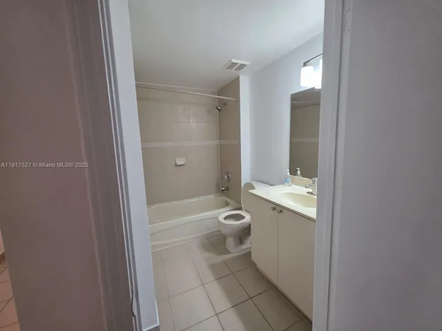 a bathroom with a granite countertop toilet a sink and bathtub