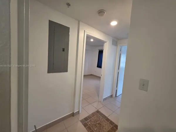 a view of hallway with bathroom