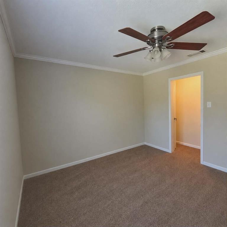 14752 Ranch Road Forney, TX 75126 - Photo 29 of 40 Bedroom 4-Neutral wall color with crown molding, carpet flooring, and a ceiling fan with light fixture-This photo was taken before family moved in