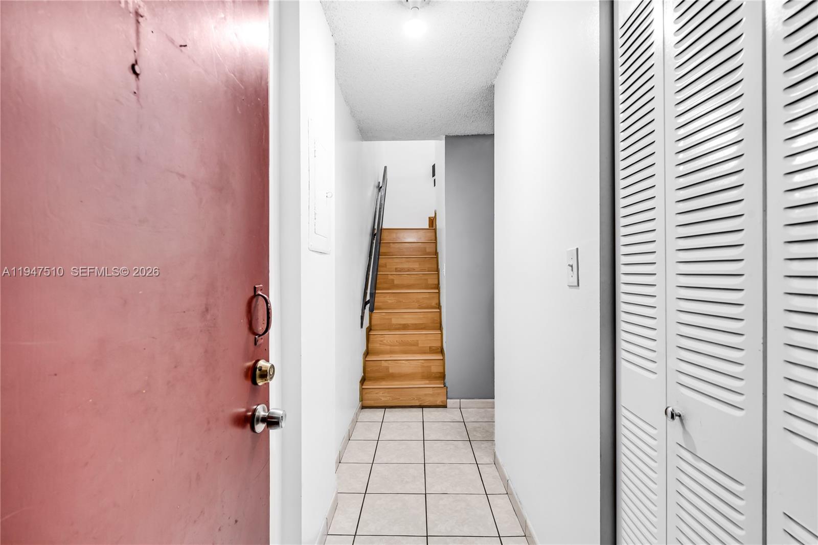 1750 West 56th Street, Unit 210 Hialeah, FL 33012 - Photo 11 of 22 a view of a hallway with wooden floor and a bathroom