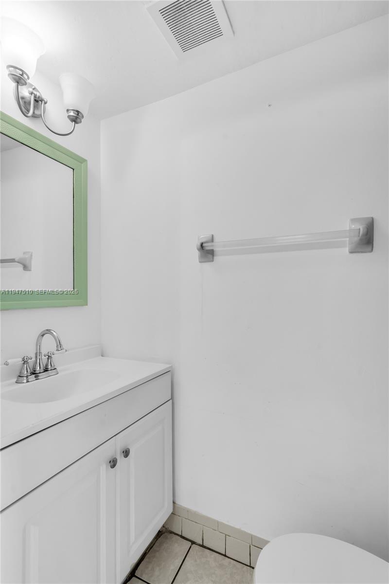 1750 West 56th Street, Unit 210 Hialeah, FL 33012 - Photo 12 of 22 a bathroom with a sink and a mirror