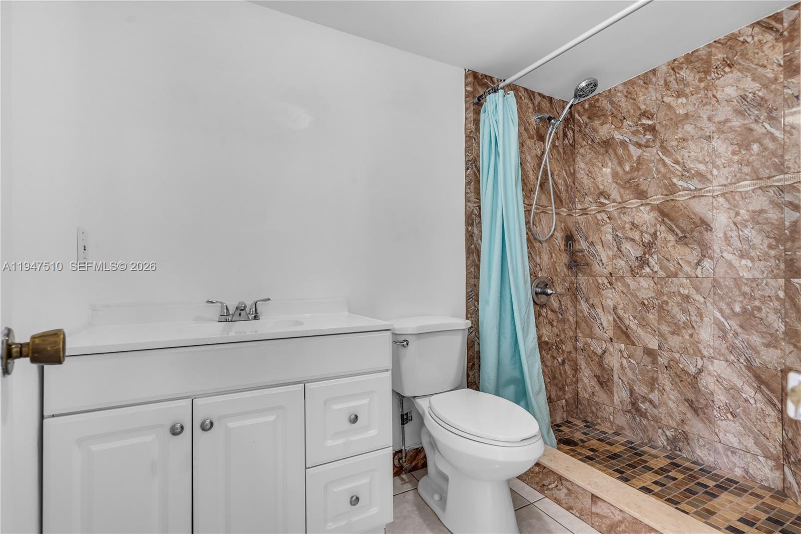 1750 West 56th Street, Unit 210 Hialeah, FL 33012 - Photo 15 of 22 a bathroom with a granite countertop toilet sink and shower