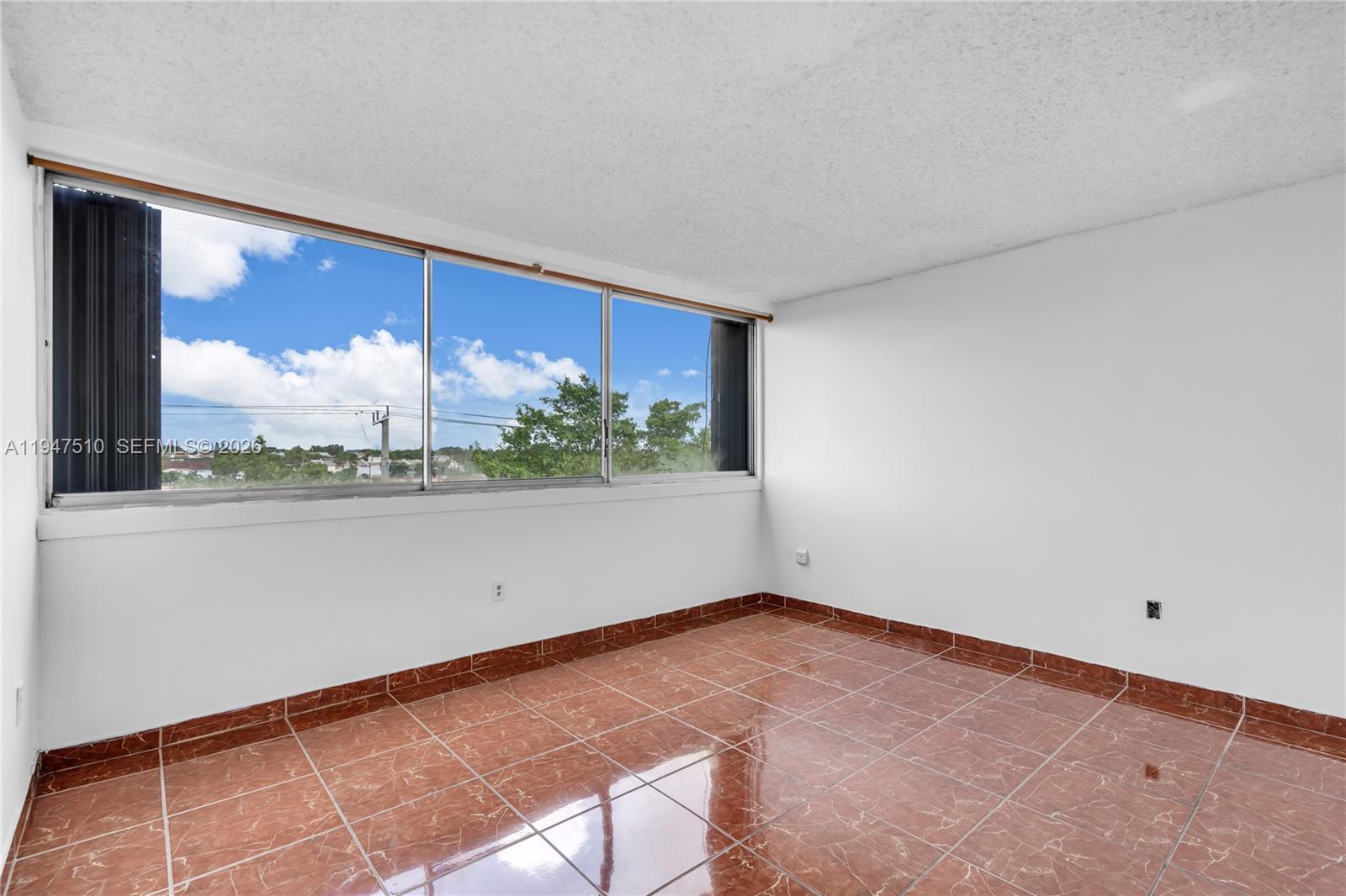 1750 West 56th Street, Unit 210 Hialeah, FL 33012 - Photo 18 of 22 a view of a room with wooden floor