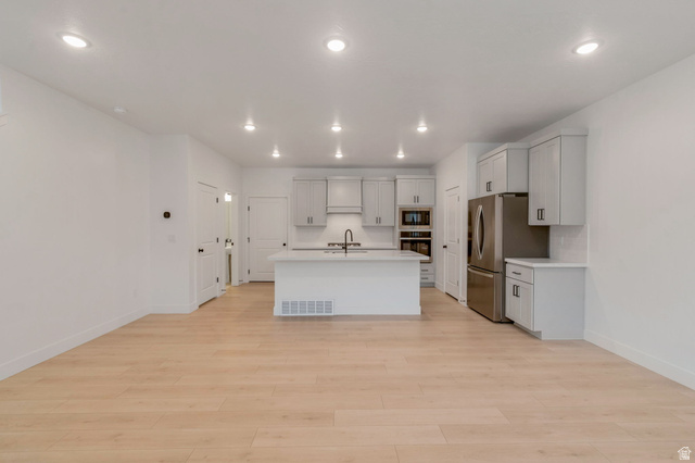 30 South Moonlit Road Mapleton, UT 84664 - Photo 7 of 25 Open-concept living space featuring wood-finish flooring, recessed lighting, and a contemporary kitchen