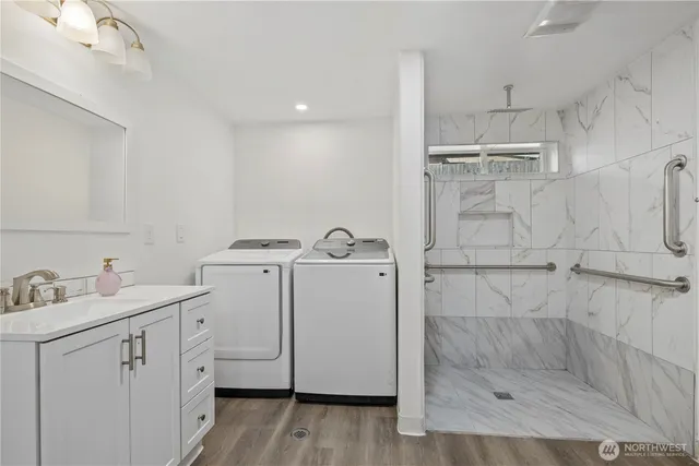 a bathroom with a granite countertop sink a toilet and shower