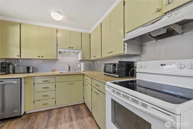 a kitchen with granite countertop cabinets stainless steel appliances and a sink