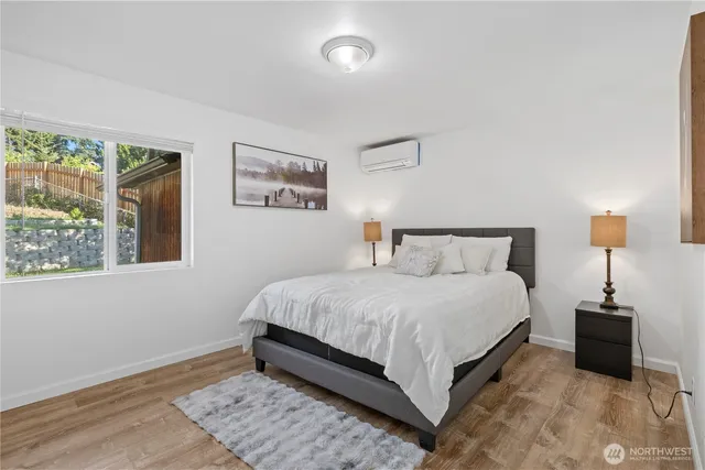 a bedroom with a bed and a lamp